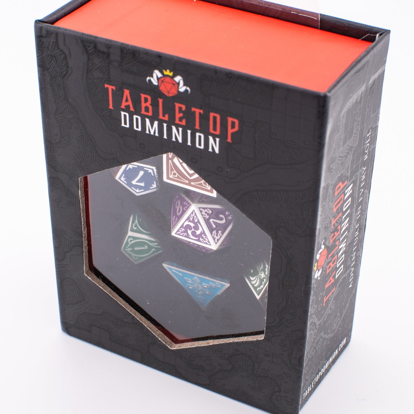 Tabletop Dominion Prismatic Elemental metal dice set in a closed display box with multicoloured dice visible through the top window.