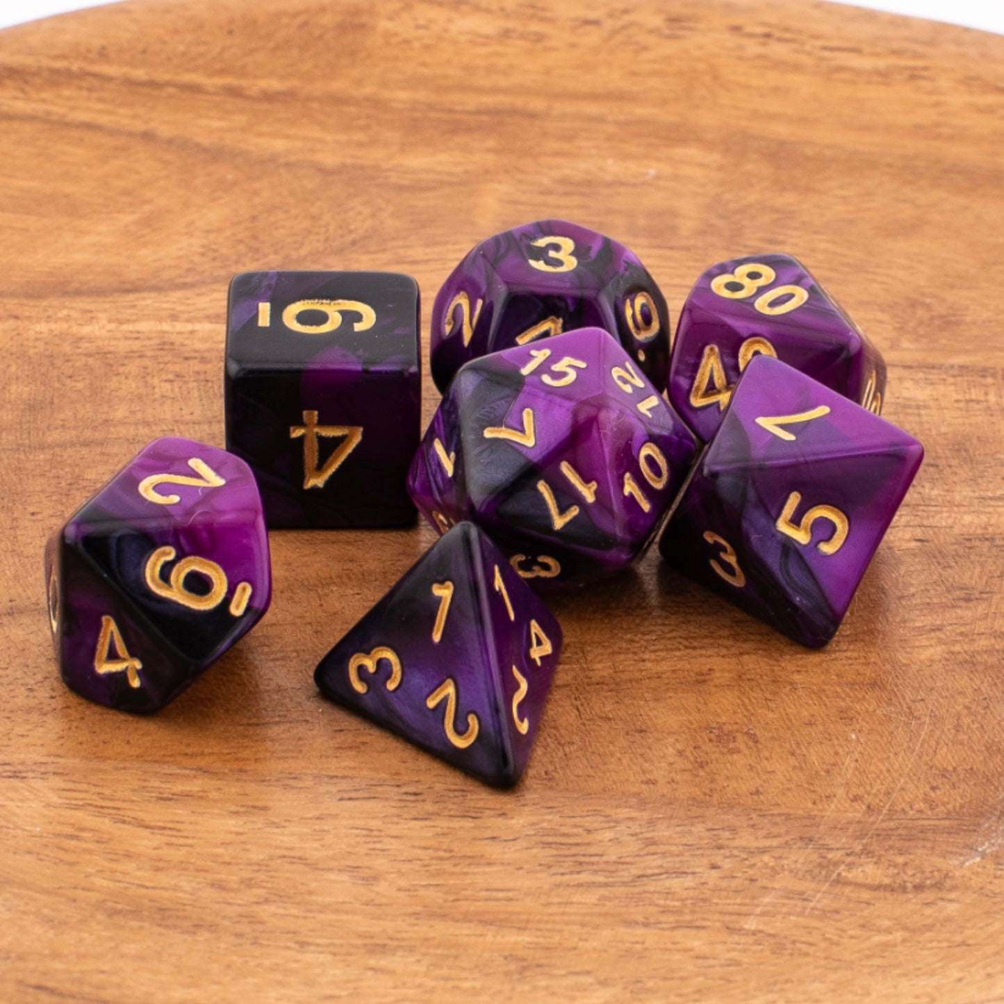 Twilight Shroud acrylic dice arranged across a wooden surface.