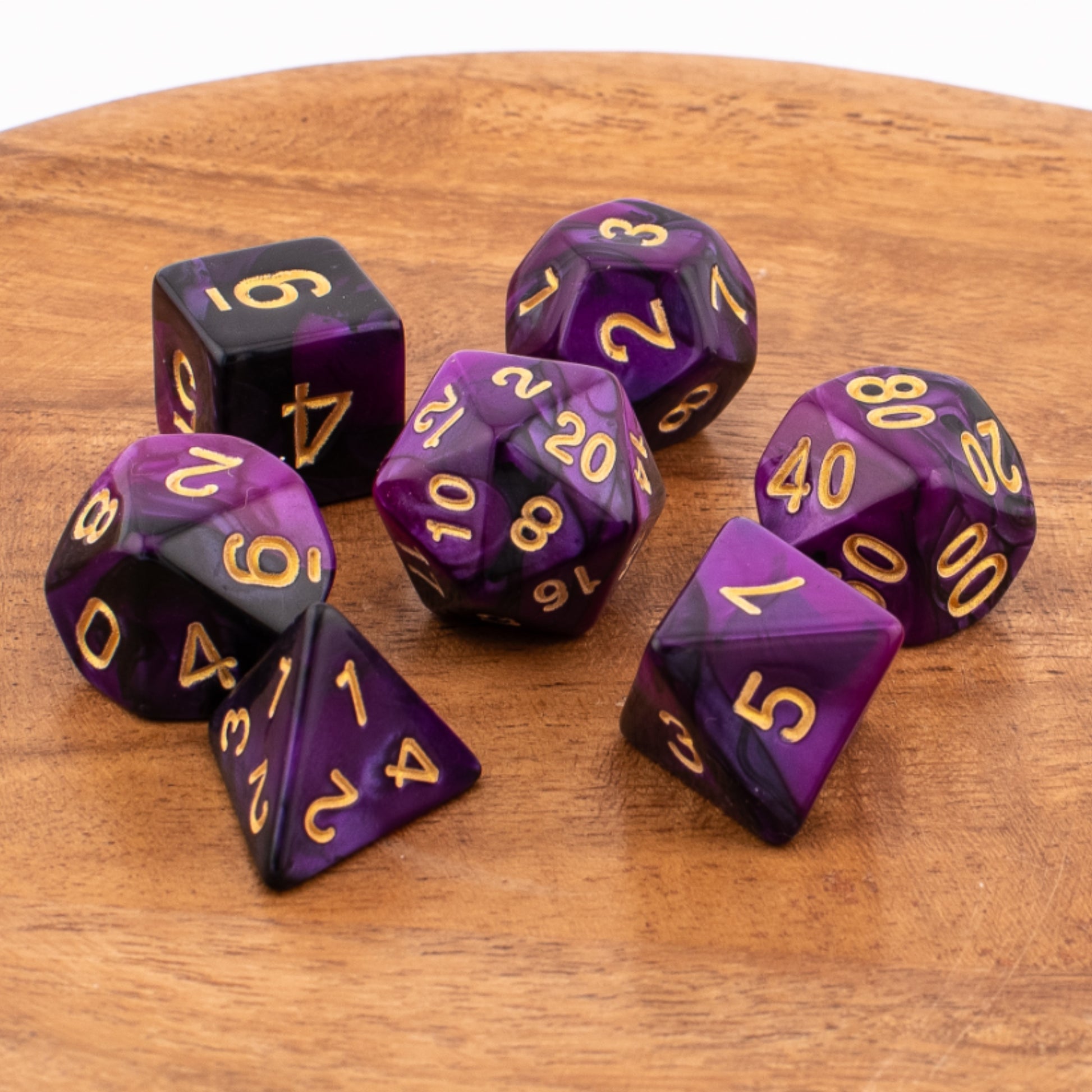 Twilight Shroud acrylic dice scattered across a wooden surface.