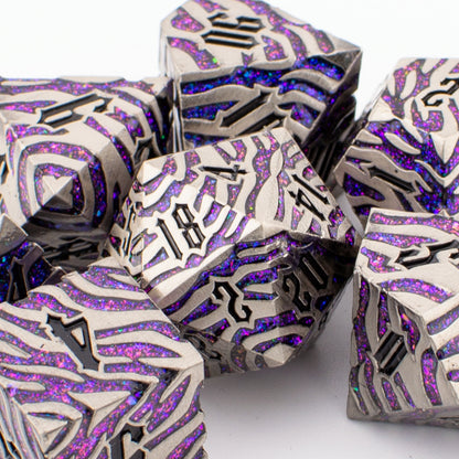 Nebula Covenant solid metal purple‑sparkle RPG dice set displayed in an open Tabletop Dominion box, featuring seven engraved polyhedral dice arranged in a foam insert.