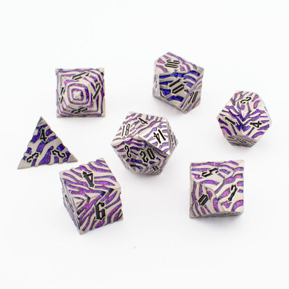 Nebula Covenant solid metal purple‑sparkle RPG dice set arranged loosely, showing all seven engraved polyhedral dice with metallic detailing and shimmering purple inlays.