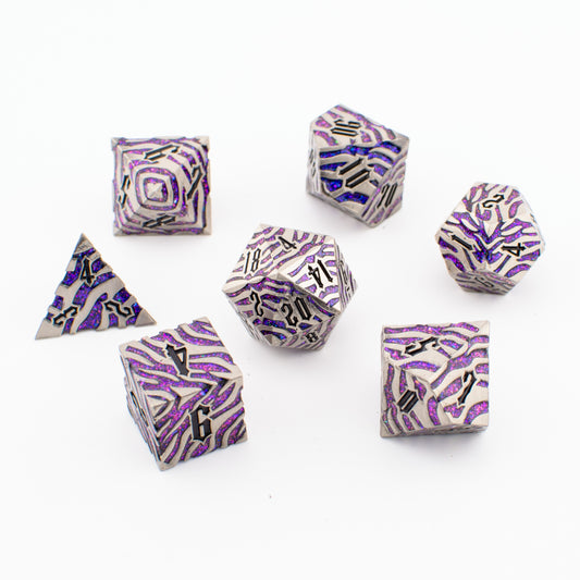 Nebula Covenant solid metal purple‑sparkle RPG dice set arranged loosely, showing all seven engraved polyhedral dice with metallic detailing and shimmering purple inlays.