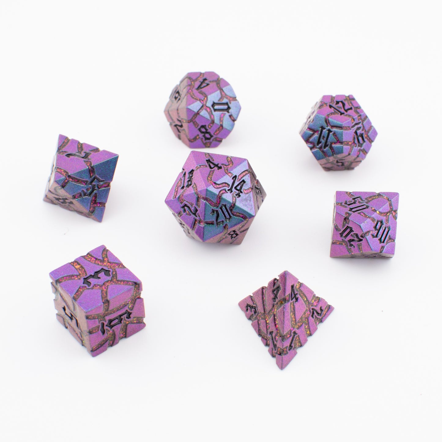 Macro close‑up of Void Weaver metal polyhedral dice, focusing on enamel colour gradients and sharp engraved edges.
