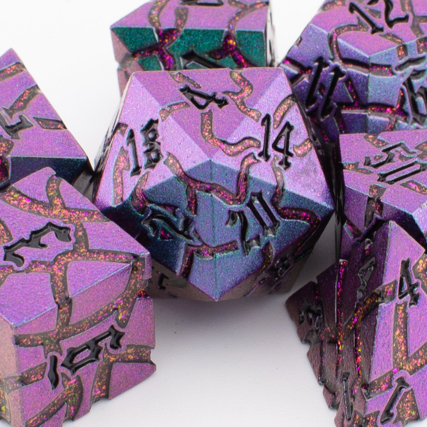 Void Weaver solid metal RPG dice set with purple and blue enamel arranged loosely on a white background, showing all seven engraved polyhedral dice.
