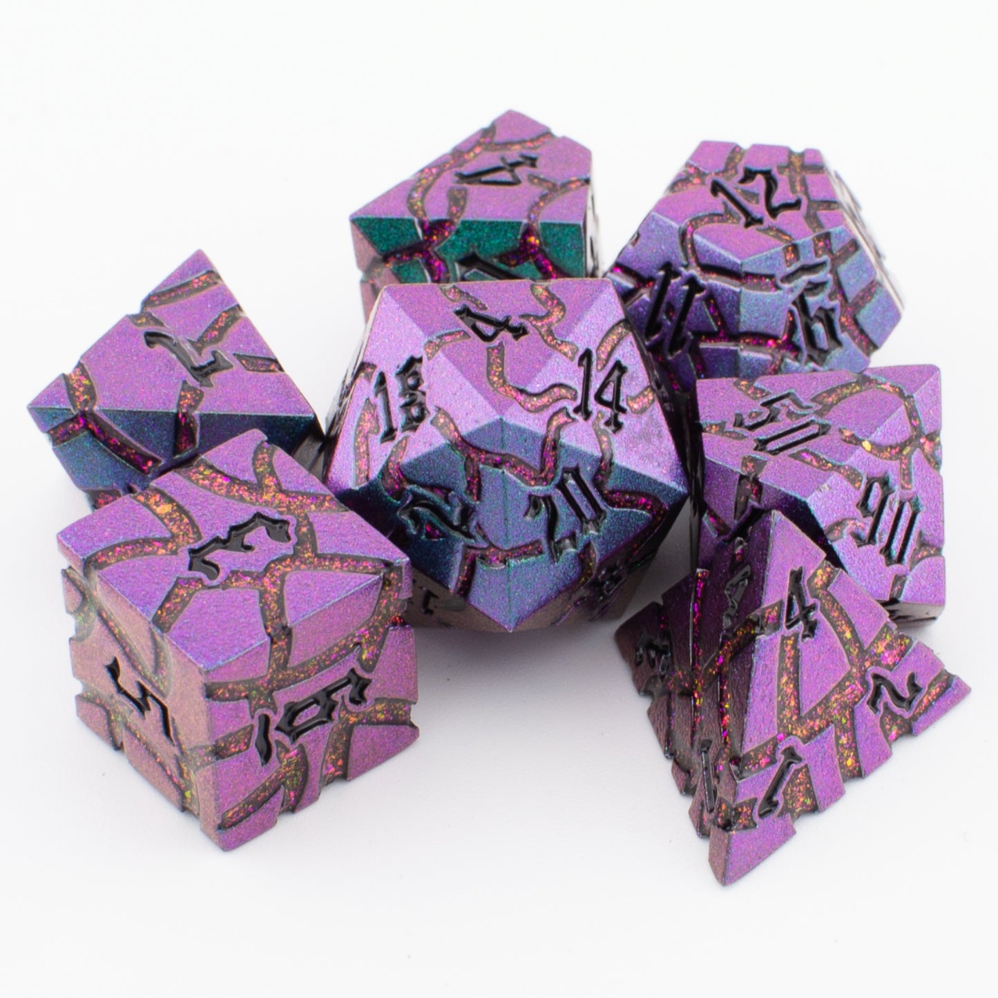 Void Weaver metal polyhedral dice set displayed loosely on a white surface, highlighting the enamel colours and intricate engraved detailing.