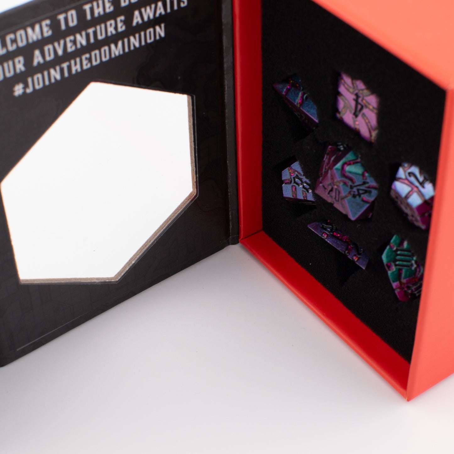 Void Weaver solid metal RPG dice set with purple and blue enamel displayed in an open Tabletop Dominion box, featuring seven engraved polyhedral dice arranged in a foam insert.