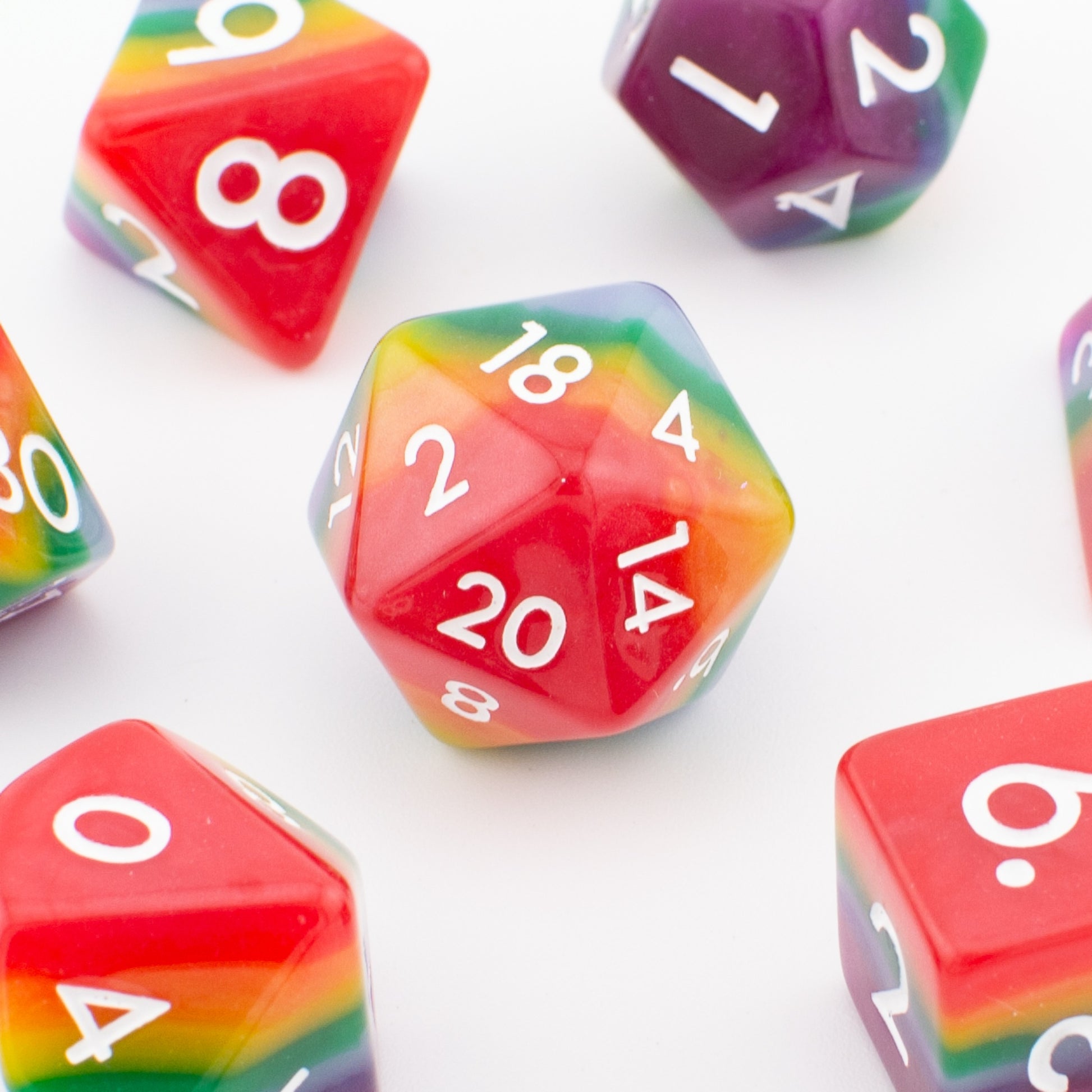 Close‑up of the Rainbow Pride soft‑edge acrylic D20 die, highlighting its rainbow gradient and polished soft‑edge finish.