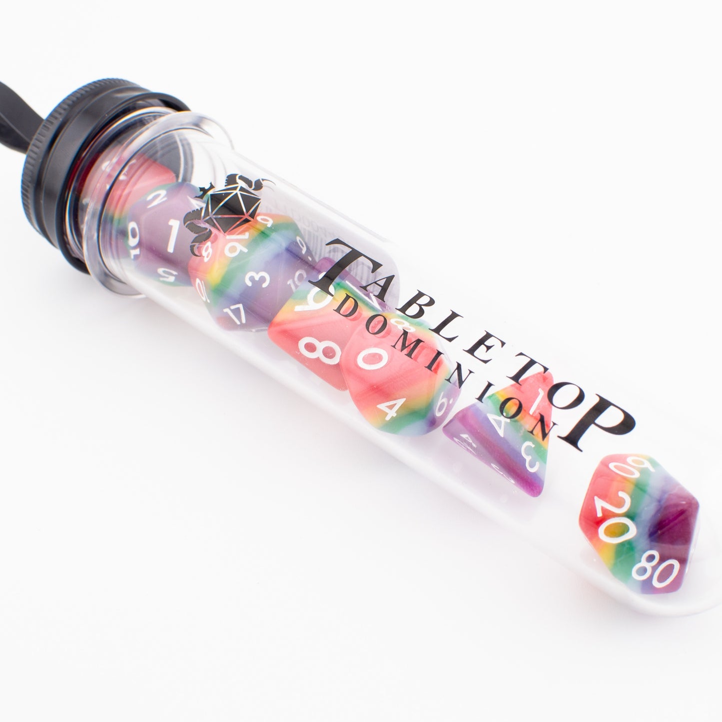 Rainbow Pride soft‑edge acrylic RPG dice set packaged in a clear display tube, showing all seven colourful polyhedral dice.
