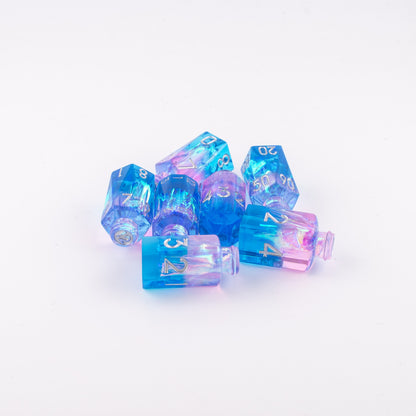 Tabletop Dominion Prismatic Elixir potion bottle dice arranged together showing blue‑to‑pink iridescent resin with metallic numbering.
