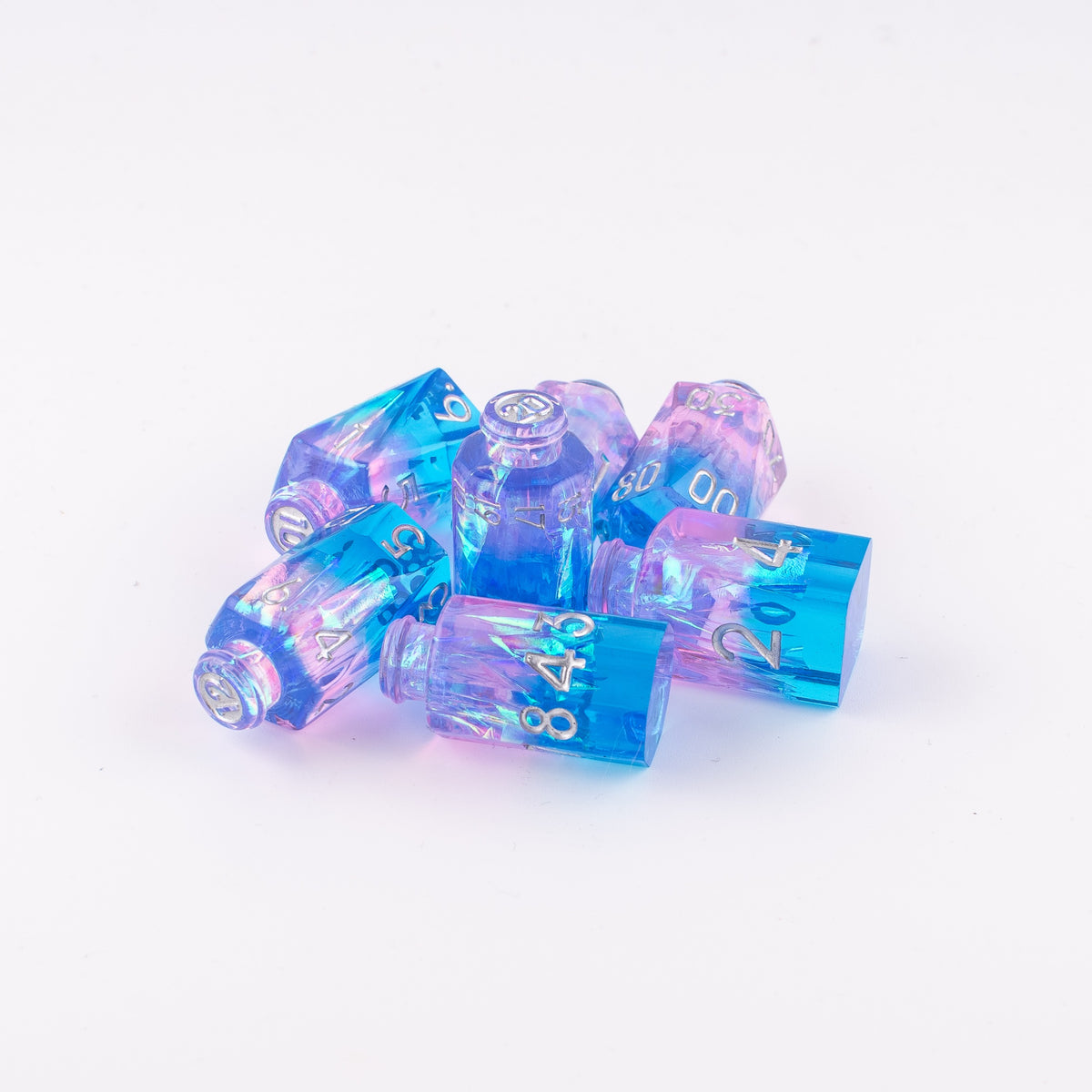Tabletop Dominion Prismatic Elixir potion bottle dice arranged in a small pile on a white background with blue‑pink iridescent resin and silver numbering.