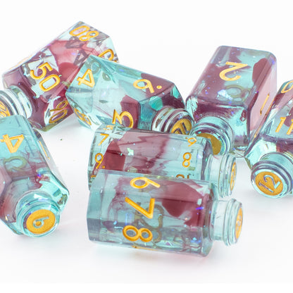 Tabletop Dominion Blood Alchemist potion bottle dice shown loose, featuring translucent turquoise‑red resin with gold numbering.