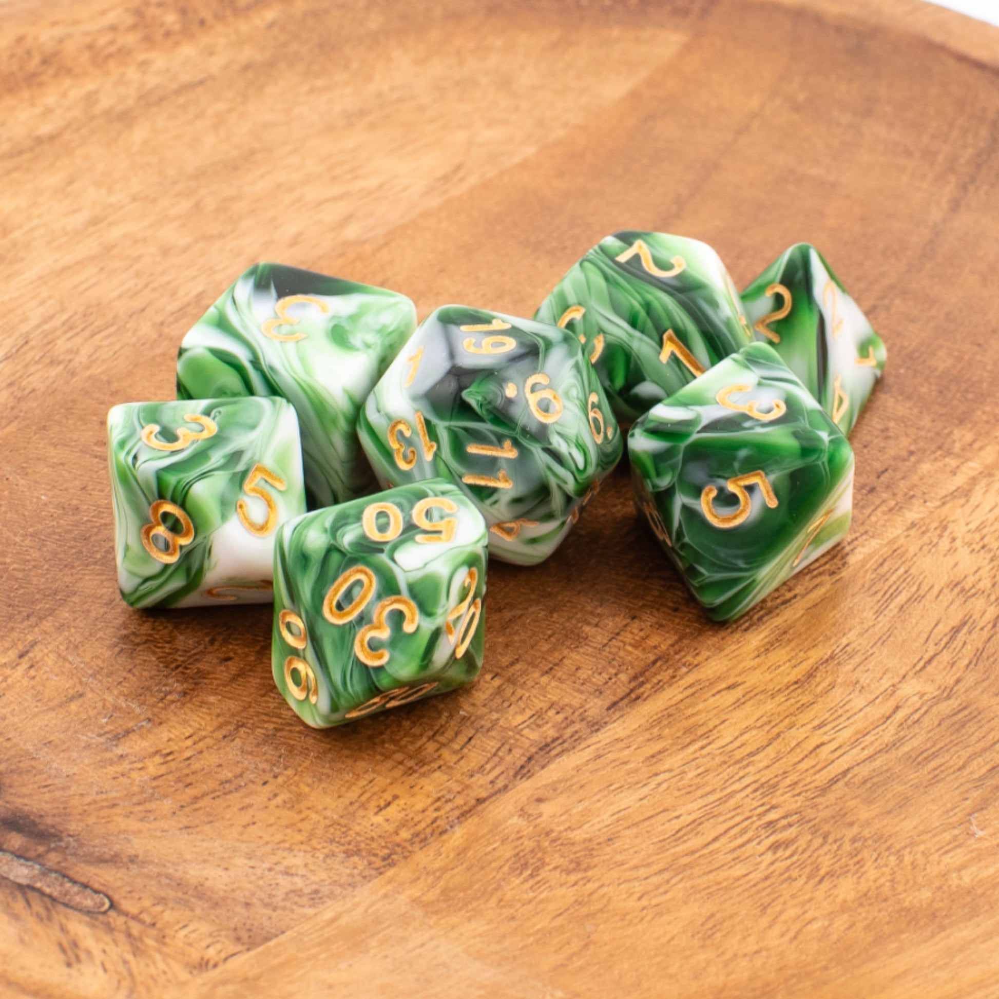 Forest Sprout acrylic dice arranged neatly on a wooden surface.