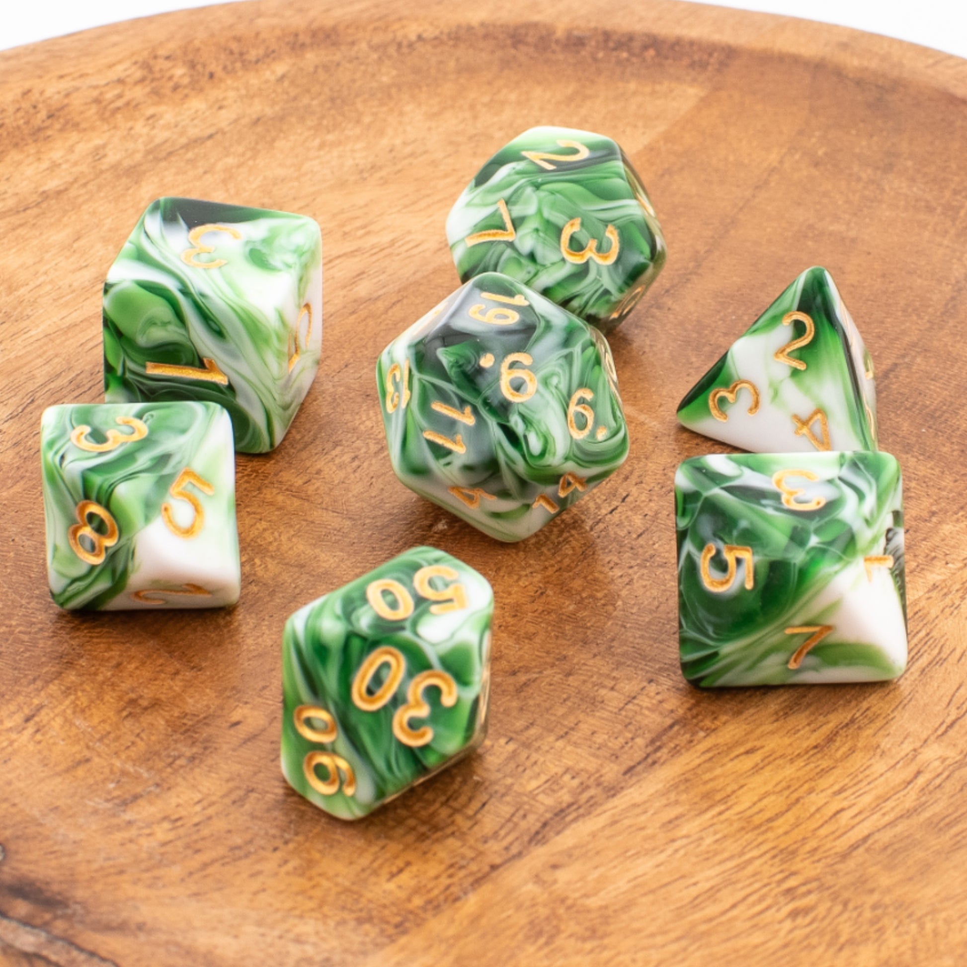 Forest Sprout acrylic dice scattered across a wooden tabletop.