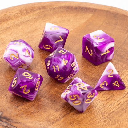Celestial Whisper acrylic dice scattered across a wooden tabletop.