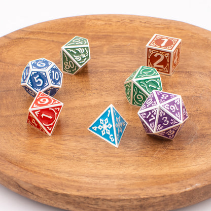 Tabletop Dominion Prismatic Elemental metal dice arranged on a wooden plate, featuring multicoloured engraved designs across all seven polyhedral shapes.