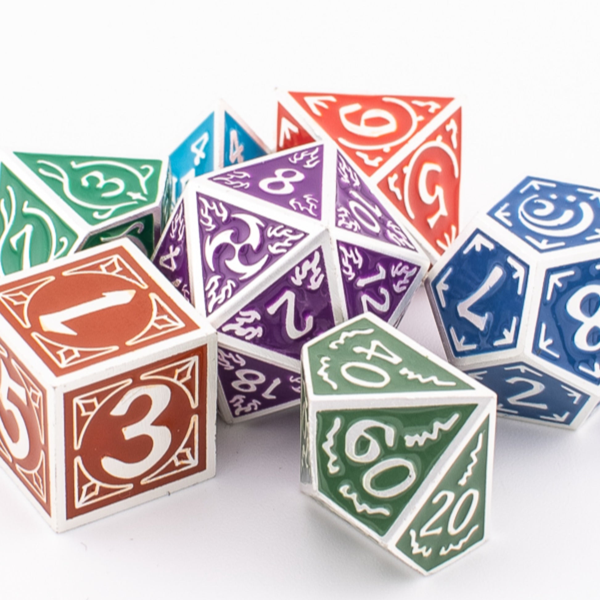 Tabletop Dominion Prismatic Elemental metal dice grouped closely together, showing multicoloured engraved designs across all seven polyhedral shapes.