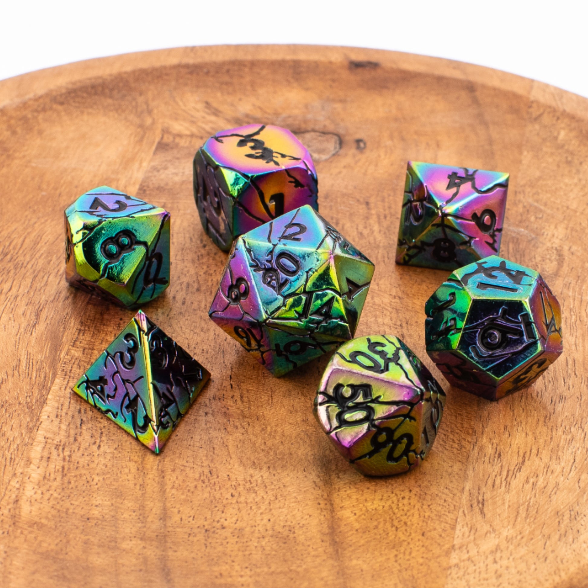 Tabletop Dominion Synthwave Nexus metal dice arranged on a wooden surface with an iridescent rainbow finish and black numbering.