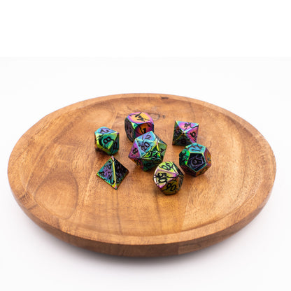 Tabletop Dominion Synthwave Nexus metal dice arranged on a wooden tray with an iridescent rainbow finish and black numbering.