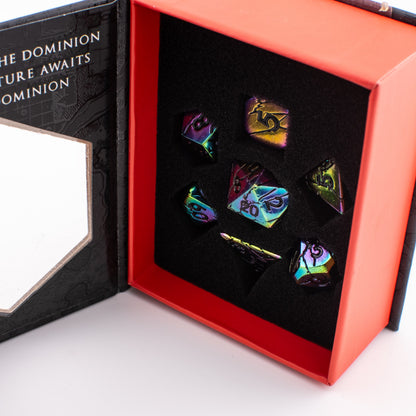 Tabletop Dominion Synthwave Nexus metal dice set displayed in an open box with iridescent rainbow‑finish dice arranged in a foam insert.