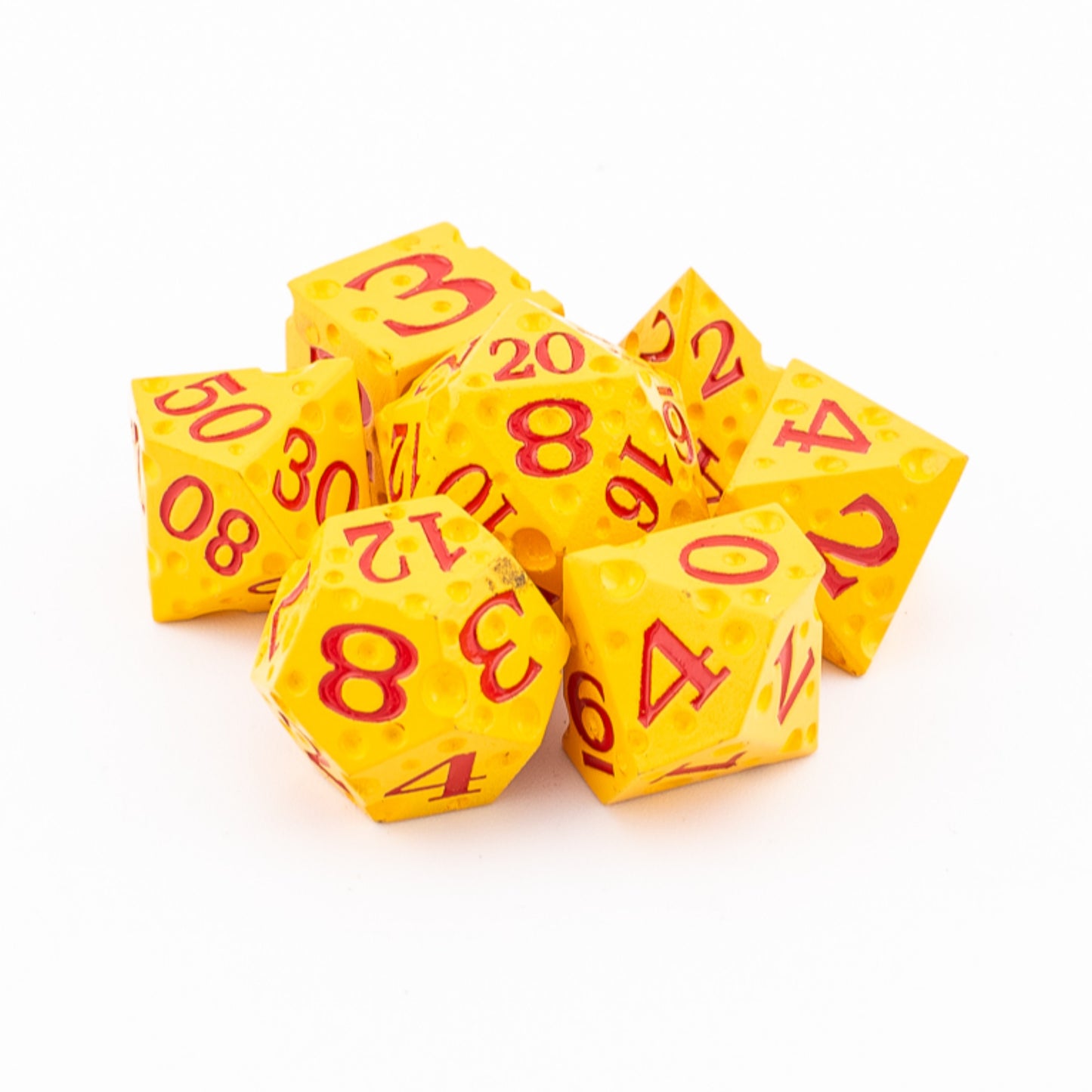 Tabletop Dominion Cheddar Champion heavy metal dice piled together with a cheese‑like yellow texture and red numbering.
