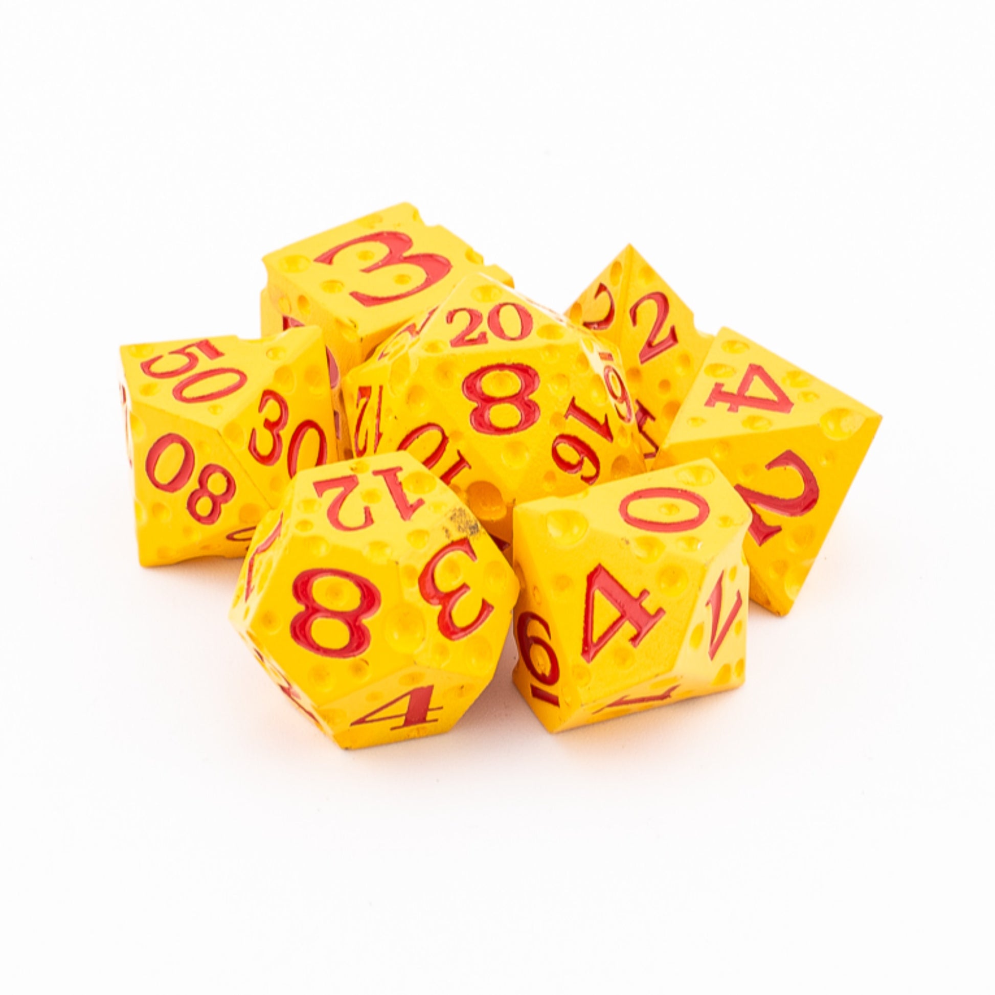Tabletop Dominion Cheddar Champion heavy metal dice piled together with a cheese‑like yellow texture and red numbering.
