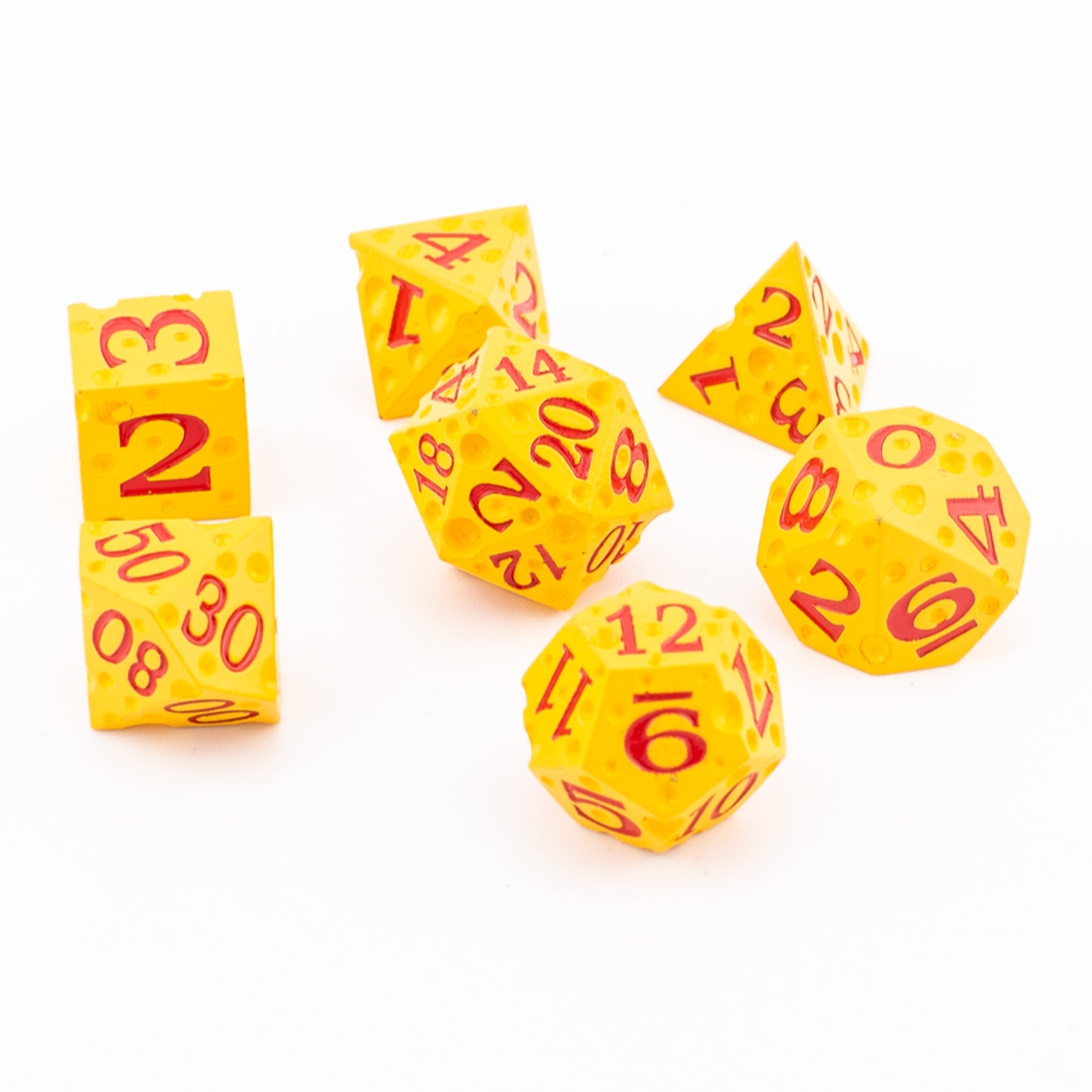 Tabletop Dominion Cheddar Champion heavy metal dice arranged together with a cheese‑like yellow texture and red numbering.