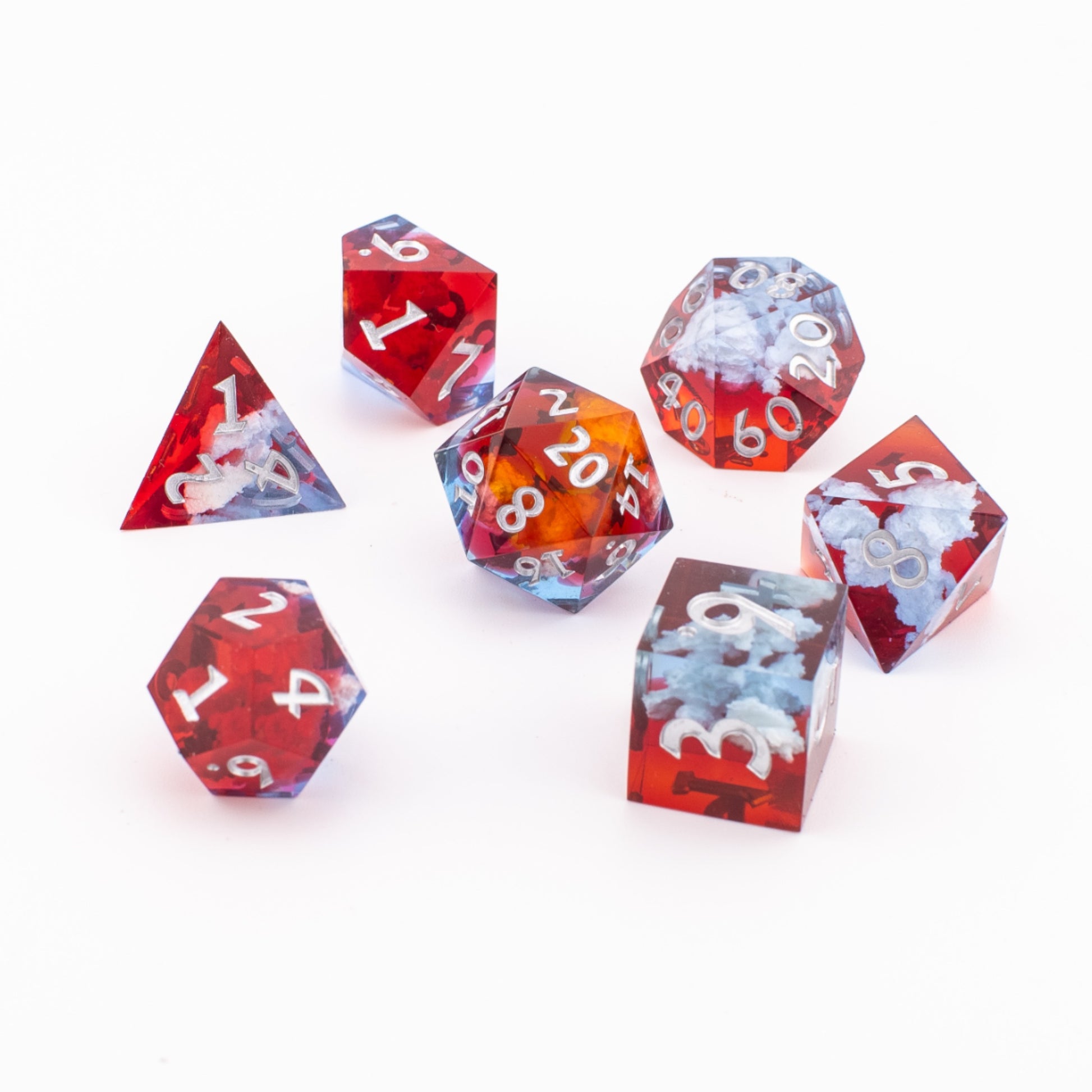 Ember Cloud sharp‑edge resin dice arranged on a white background, showing all seven dice with red‑and‑blue cloud inclusions and white numbering.