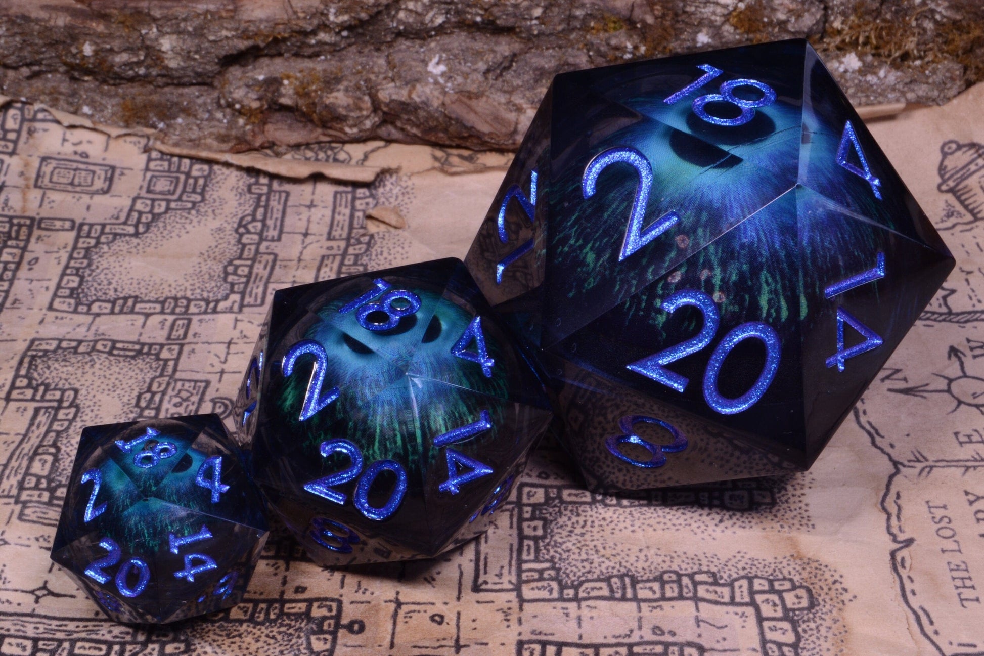Front facing view of the evil eye moving eyeball liquid core dice, showing the three size options